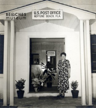 Mrs. Evelyn Corbin Hunter, Postmistress Neptune Beach Post Office, standing at the door of the post office at 210 Magnolia, 1948